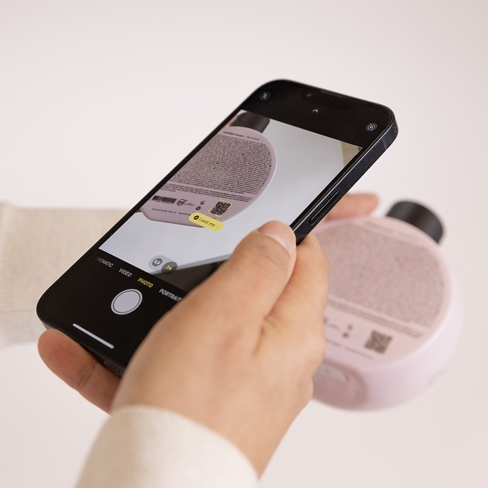 Phone scanning the QR code on a bottle