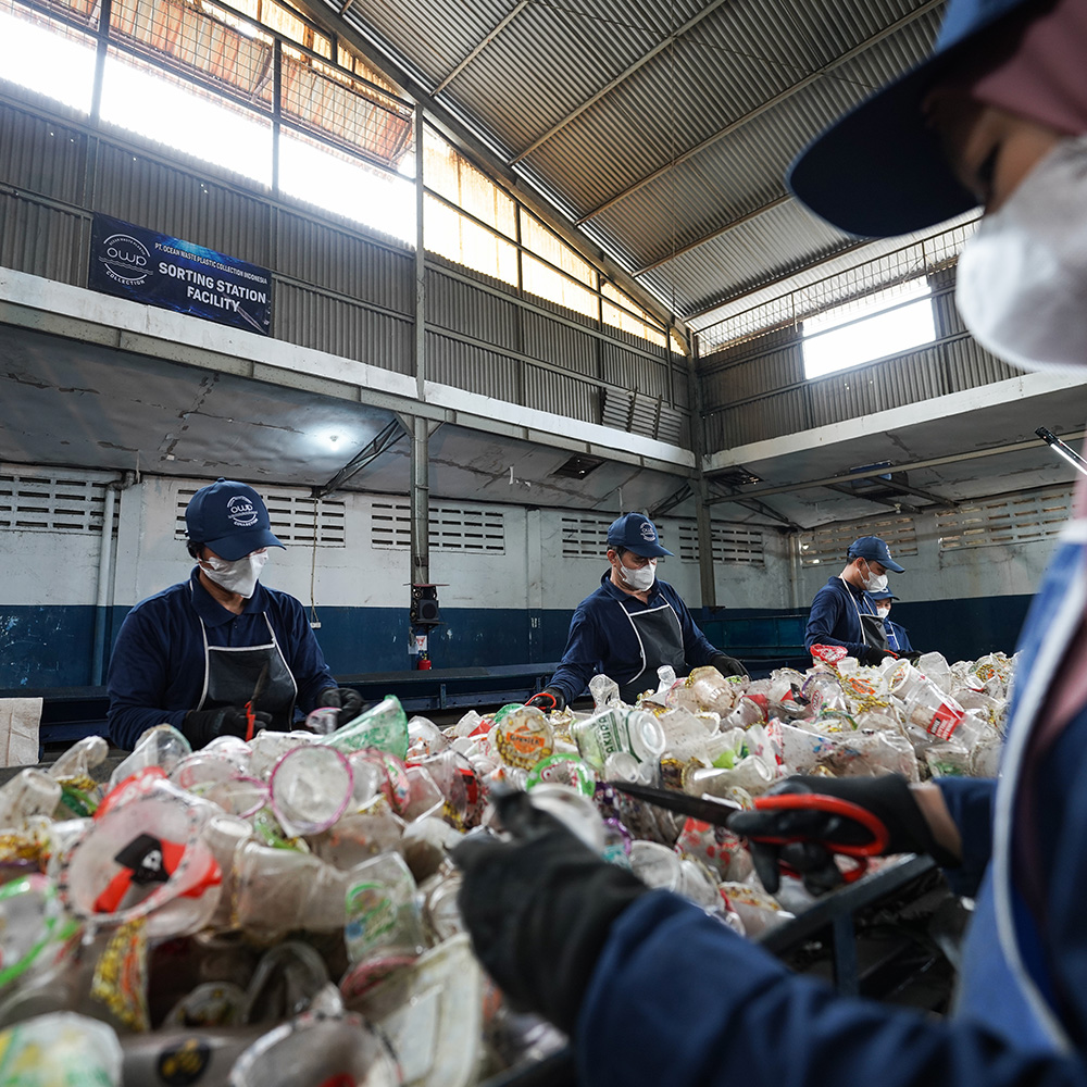 Team sorting collected plastic by hand